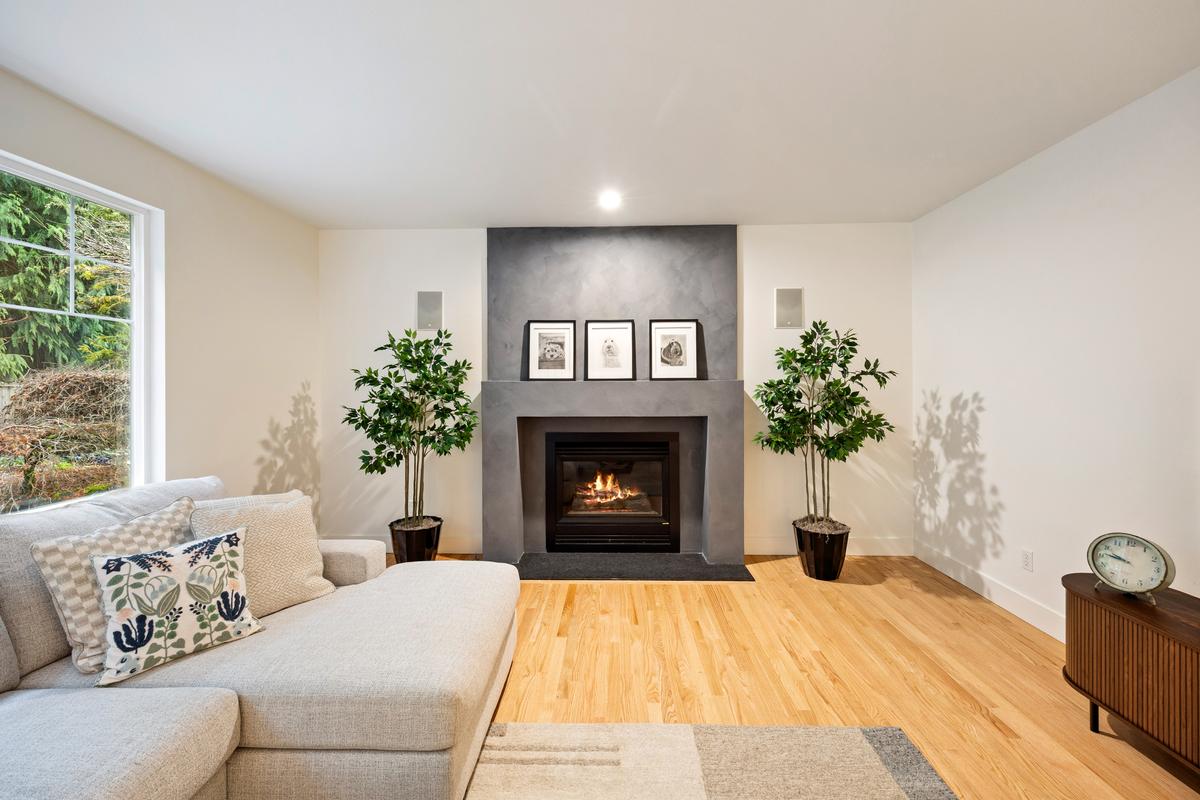 Open-concept living room in Olympia whole house remodel with modern fireplace and luxury finishes