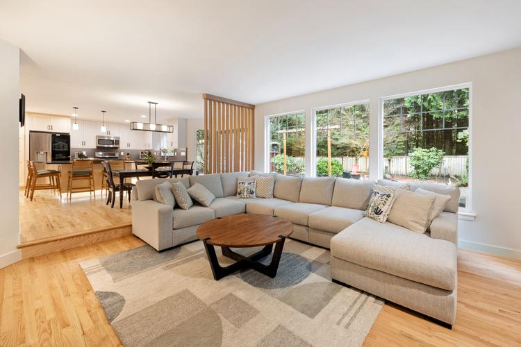 Open-concept living room in Olympia whole house remodel with modern fireplace and luxury finishes